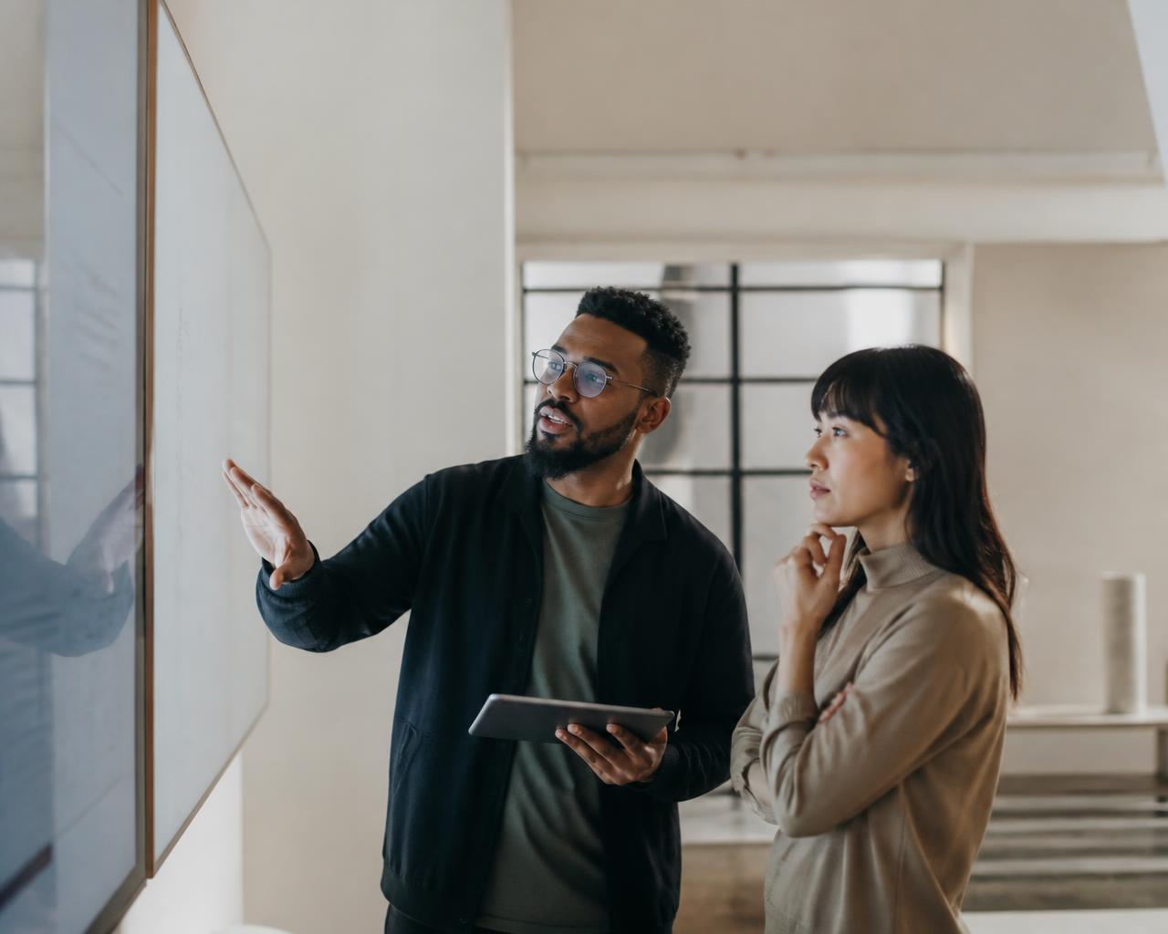 Two founders mapping strategy on a whiteboard